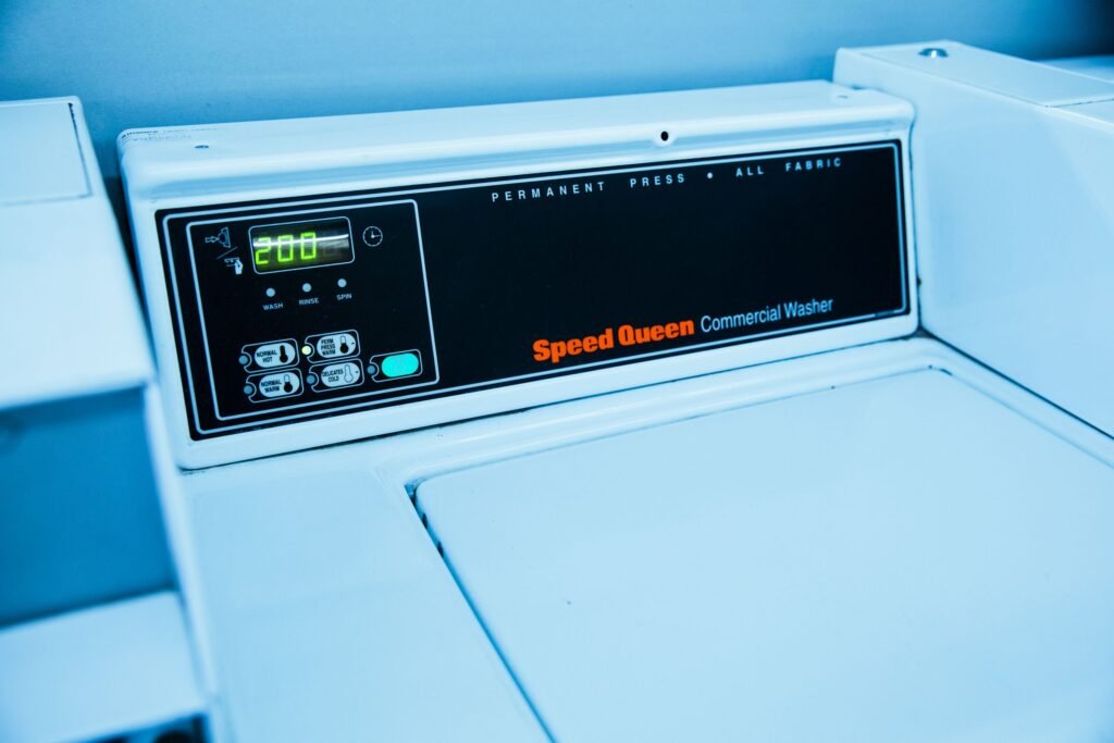 Close-up of a washing machine control panel with buttons and dial