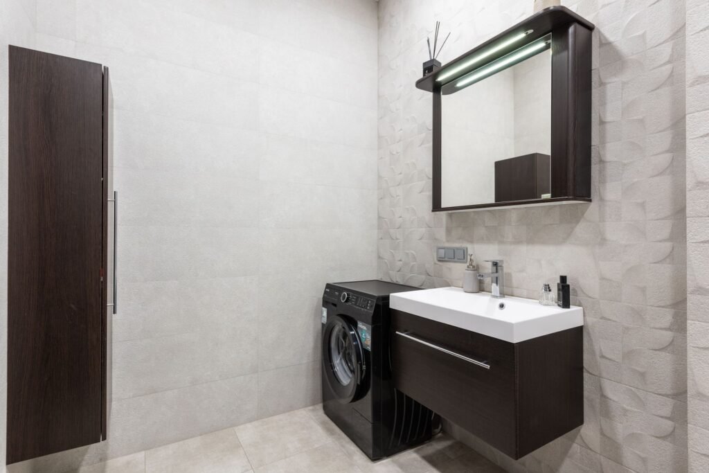 Washing machine installed beside a sink and water connection