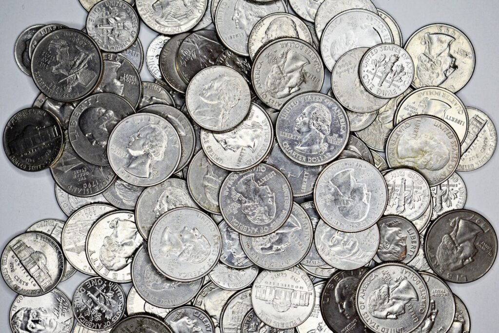 Close-up collection of coins, a common cause of a washer drain pump humming without draining