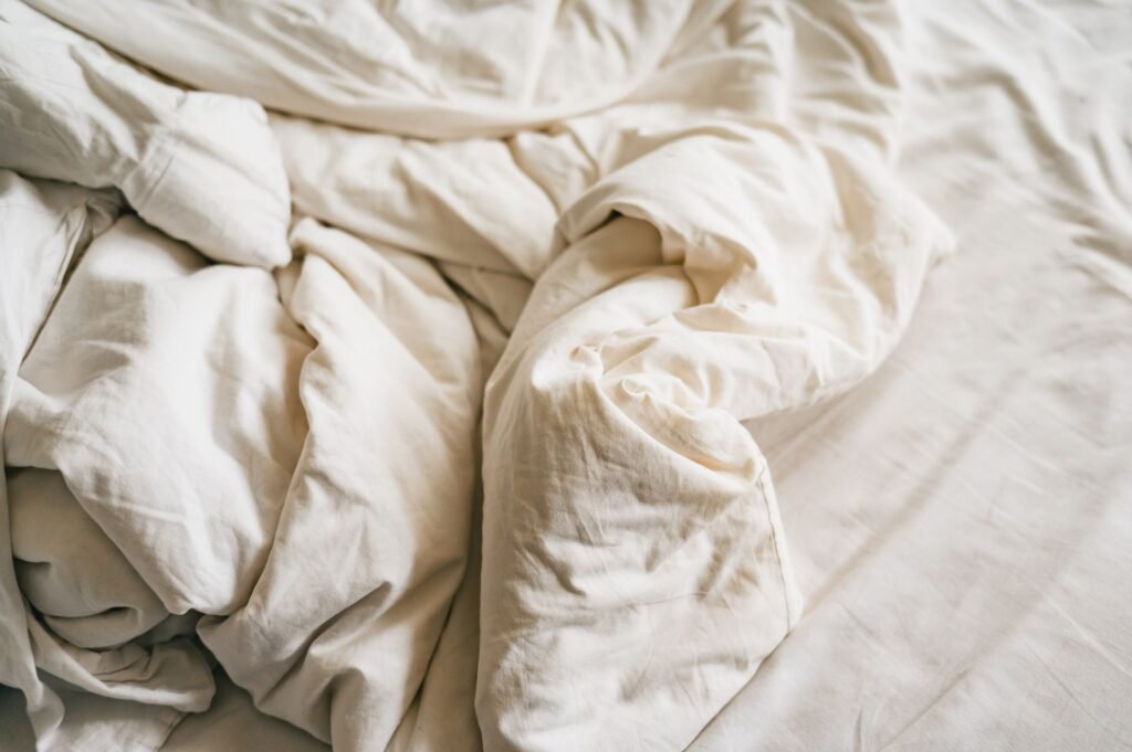 Close-up of white linen bedding, relevant to a Samsung washer UE or Ub error triggered by bulky bedding loads