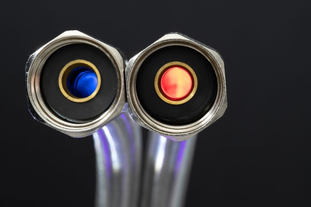Close-up of chrome hose connectors with red and blue color indicators