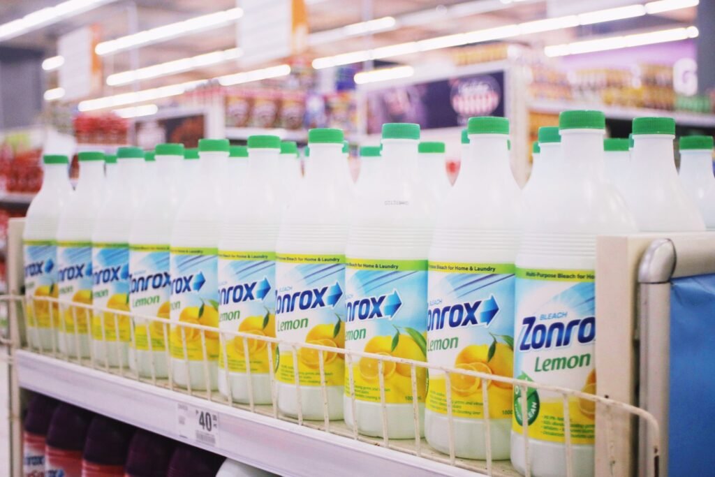 Rows of plastic bleach bottles on a shelf, relevant to running the Samsung Self Clean or Self Clean+ cycle