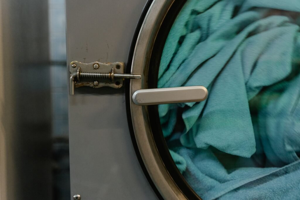 Close-up of fabric inside a front-loading washing machine drum near the door glass