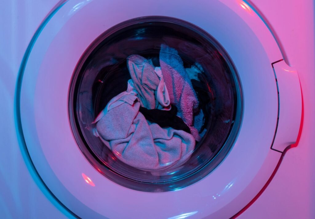 Laundry pressed against the drum of a front-load washer, where spin speed decides how much water is left behind