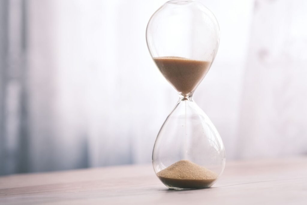 An hourglass with sand running through it, standing in for a wash cycle that keeps taking longer