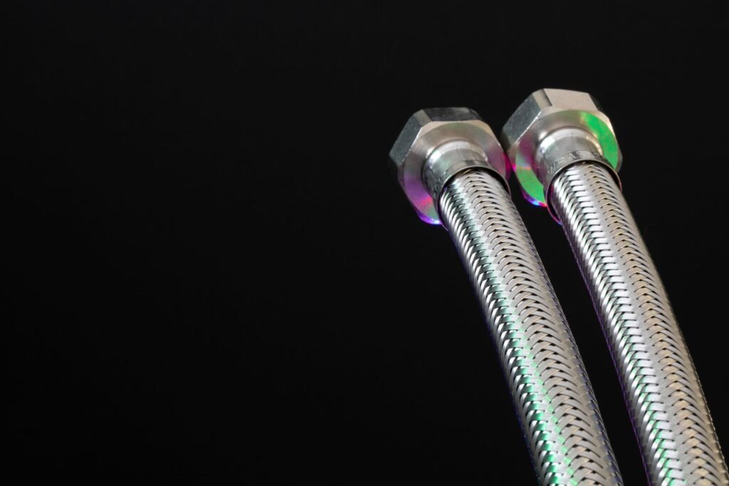 Two braided steel washing machine supply hoses, the connection behind most washing machine leaking from the bottom claims