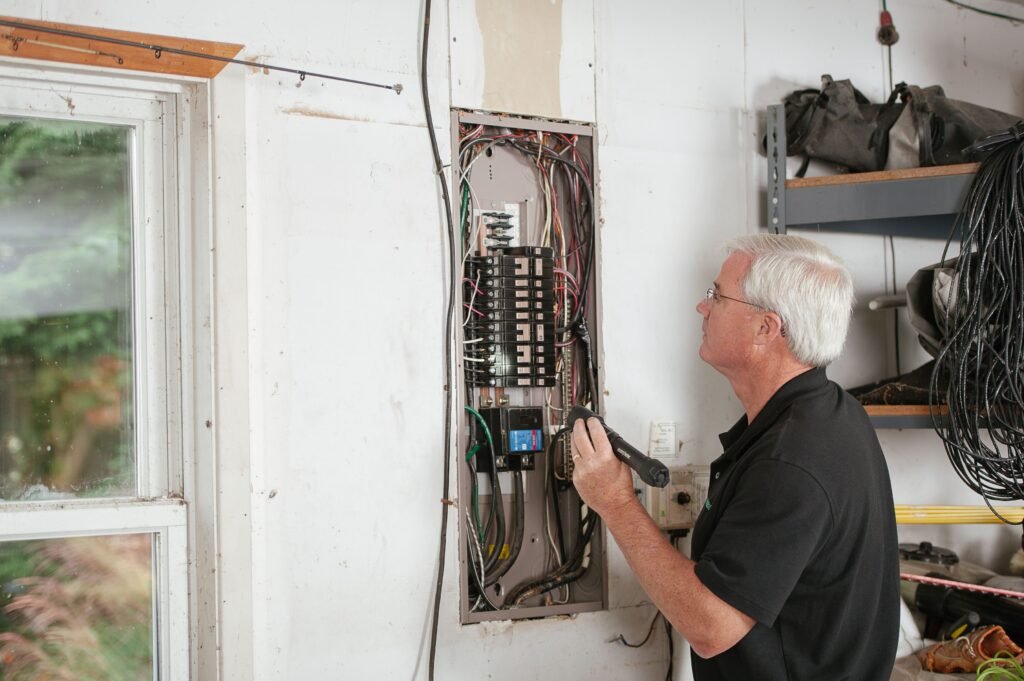Electrician checking a residential circuit breaker panel to trace why a washing machine has no power