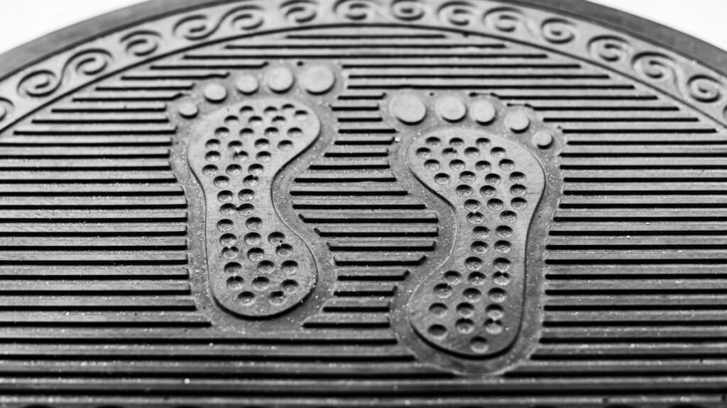 Close-up of ribbed black rubber matting, the material anti-vibration pads are cut from