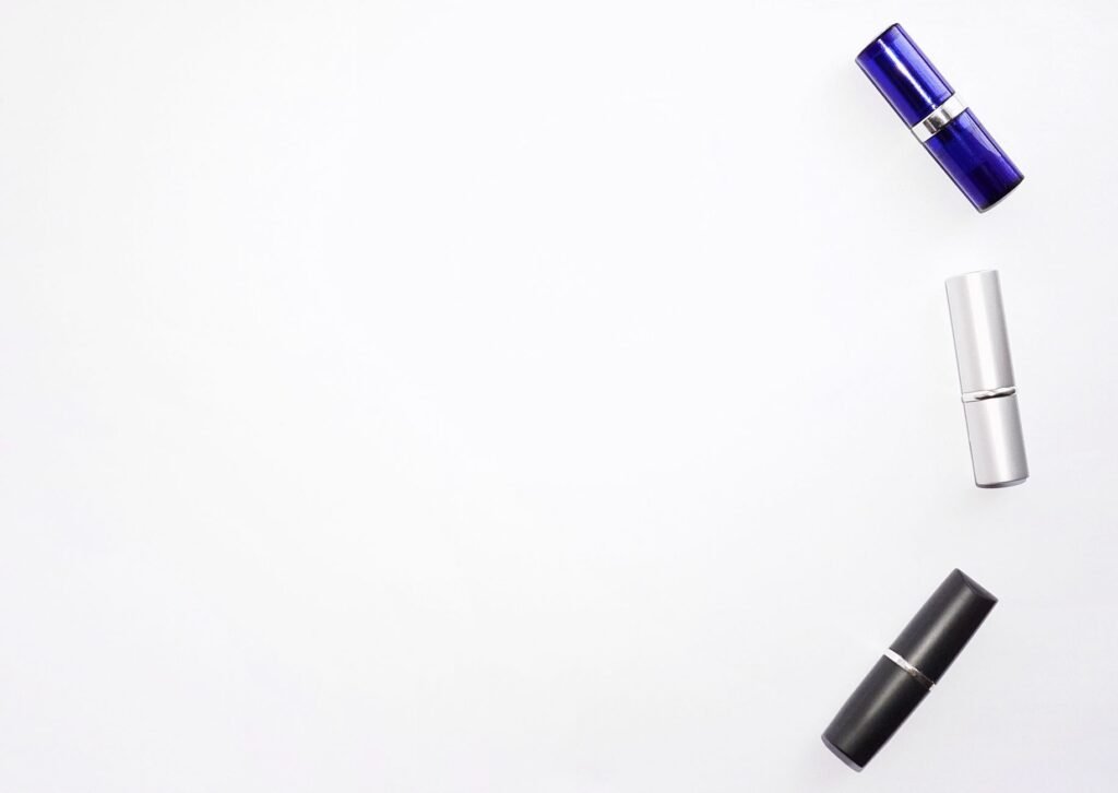 Three lipstick tubes lying on a white surface, the wax-and-pigment formulation that makes lipstick stains so hard to wash out