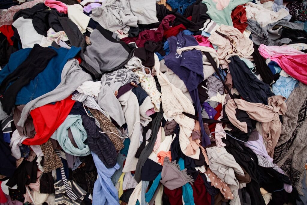 A large heap of mixed clothing in every colour, the pile before any sorting has happened