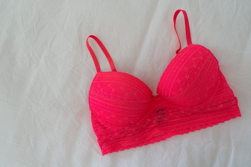 Lace bra laid flat on a white sheet, the flat drying position that keeps a washed bra in shape