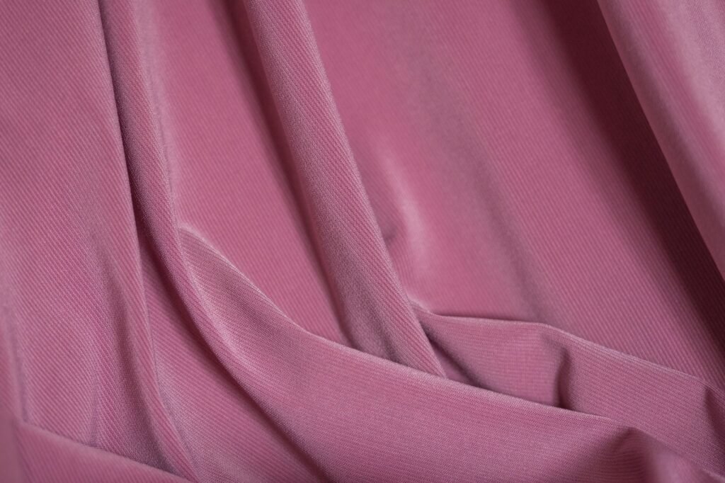 Close-up of corduroy fabric showing the raised ribbed wales and the cut pile that crushes flat