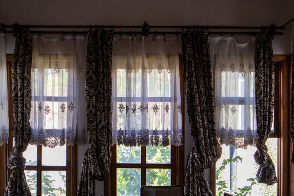 Sunlit room with long traditional curtains at the window, the drop that shrinks if curtains are washed too hot