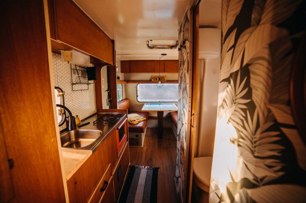 Compact camper van interior with a kitchenette, the confined space an RV washer dryer has to fit into