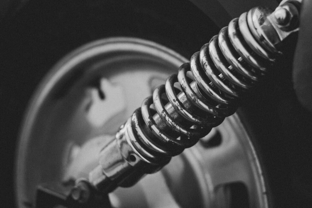 A coil spring wound around a damper shaft on a vehicle suspension, the same arrangement a washer suspension rod uses