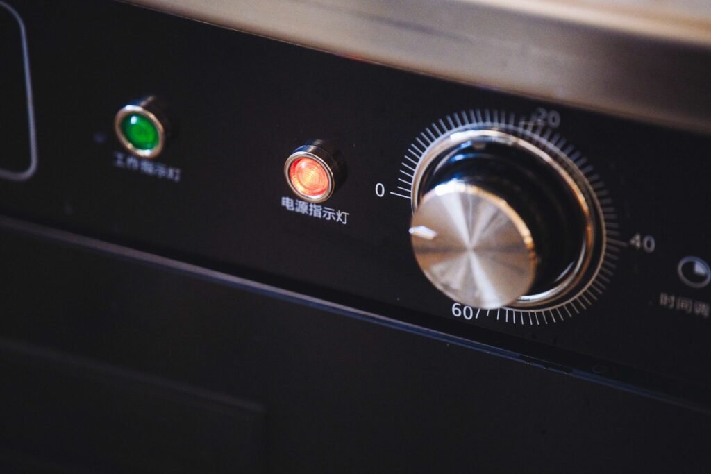 Close-up of an appliance timer dial and two indicator lights, the panel a cycle-start click comes from